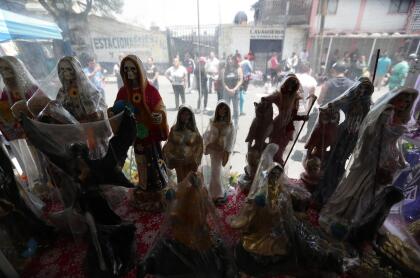 "Espero en Dios que vengan a pedirle que no se enfermen, que a sus hijos y a sus nietos no llegue la enfermedad. Si llegase a existir, que no nos llegue. Que nos cuide la Santa Muerte", recalcó Enriqueta mientras a su alrededor desfilan los fieles, dirigidos por un señor que viste una camiseta de fútbol y pantalones cortos.