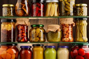 Jars with variety of pickled vegetables.