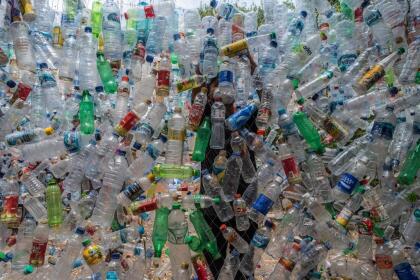 An Indonesian activist from ECOTON (ecological observation and wetland conservation) prepares an installation made with used plastic, including 4,444 bottles, collected from the river in Gresik on September 17, 2021, to raise public awareness of plastic waste in rivers and oceans. (Photo by JUNI KRISWANTO / AFP) (Photo by JUNI KRISWANTO/AFP via Getty Images)