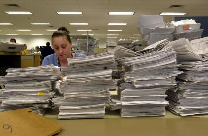 387803 05: An Internal Revenue Service employee processes tax returns in the mail room April 12, 2001 at the IRS East Coast headquarters in Brookhaven, New York. As the deadline for tax filing approaches, the IRS is now offering a variety of payment options, including e-mail and credit cards. (Photo by Spencer Platt/Newsmakers)