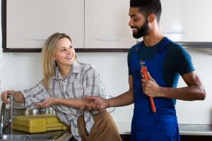 plumber and housewife in kitchen