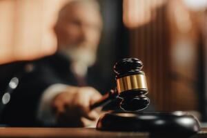 Court of Law and Justice Trial Session: Imparcial Honorable Judge Pronouncing Sentence, striking Gavel. Focus on Mallet, Hammer. Cinematic Shot of Dramatic Not Guilty Verdict. Close-up Shot.