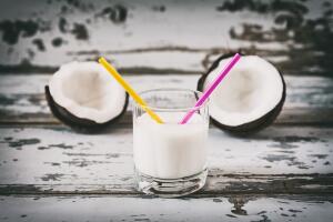Coconut milk in a glass with two straws