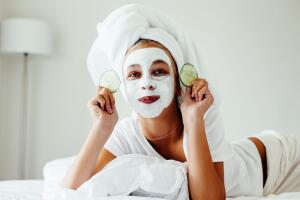 Teenage girl making facial mask