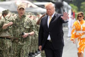 U.S. President Donald Trump gestures aboard the USS Wasp (LHD 1) in Yokosuka