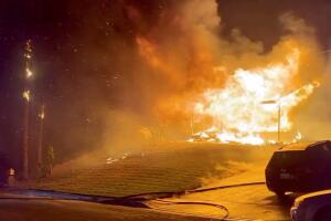 A house burns during wildfires in San Bernardino, California