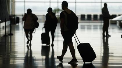 Travelers move through Salt Lake City International Airport Tuesday, Aug. 17, 2021, in Salt Lake City. (AP Photo/Rick Bowmer)