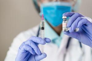 The doctor holding  a vaccine to prevent the Covid-19 virus. novel coronavirus 2019.