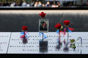 Flowers and mementos are seen left among names at the edge of the south reflecting pool at the National 9/11 Memorial and Museum during ceremonies marking the 16th anniversary of the September 11, 2001 attacks on the World Trade Center in New York