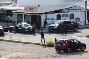 Cartel gunmen are seen on a street during clashes with federal forces following the detention of Ovidio Guzman, son of drug kingpin Joaquin "El Chapo" Guzman, in Culiacan