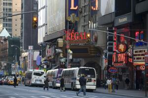 Buses and pedestrians on 42nd Street nea