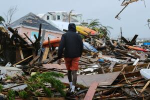 A man walks through the rubble in the aftermath of Hurricane Dorian in Marsh Harbour