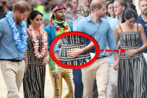 Meghan Markle toca con su mano su panza de embarazada en Australia.