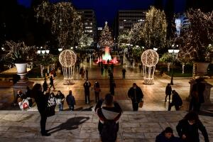 Transeúntes toman fotos de las decoraciones navideñas en la plaza Syntagma de Atenas, Grecia, el 21 de diciembre del 2020.