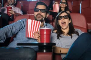 Surprised couple watching a 3d movie
