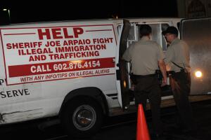 An illegal immigrant is processed by She