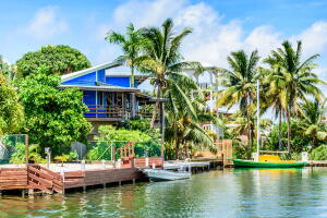 Blue waterside house & boats, Placencia, Belize,
