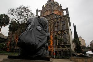 A group of environmentalists place gas masks on the faces of the sculptures of the artist Fernando Botero, protesting the high levels of air pollution in Medellin