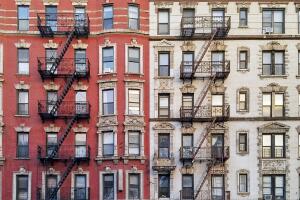 New York City historic apartment building panoramic view with windows and fire escapes