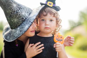 Two little sisters dressed like witches, trick or treat