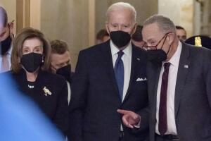 El presidente Joe Biden, flanqueado por la presidenta de la Cámara de Representantes, Nancy Pelosi, y el líder de la mayoría en el Senado, Chuck Schumer.