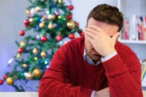 Sad man feeling negative emotions  and alone during christmas
