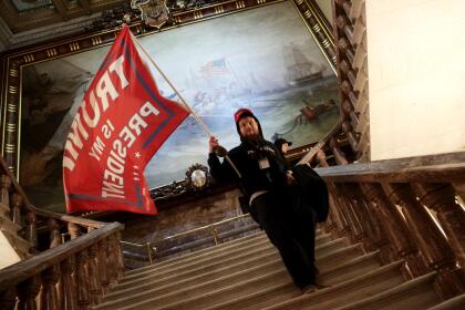 WASHINGTON, DC - JANUARY 06: A protester holds a Trump flag inside the US Capitol Building near the Senate Chamber on January 06, 2021 in Washington, DC. Congress held a joint session today to ratify President-elect Joe Biden's 306-232 Electoral College win over President Donald Trump. A group of Republican senators said they would reject the Electoral College votes of several states unless Congress appointed a commission to audit the election results. (Photo by Win McNamee/Getty Images)