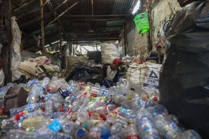 A garbage collector sorts plastic bottles in Surabaya on September 15, 2021. (Photo by Juni Kriswanto / AFP) (Photo by JUNI KRISWANTO/AFP via Getty Images)