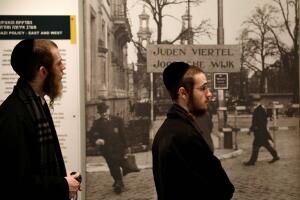 Ultra-Orthodox Jewish visitors stand next to an exhibit during a visit to Yad Vashem's Holocaust History Museum in Jerusalem