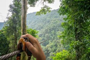Enjoying with a zipline Adventure across the mountain for watch the scenery of the sky and forest.