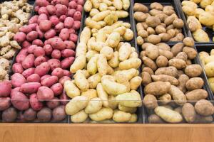 Different colors and varieties of potatoes in a grocery store