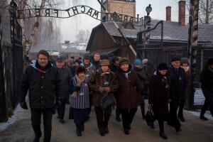 Survivors walk in the former Nazi German concentration and extermination camp Auschwitz-Birkenau in Oswiecim