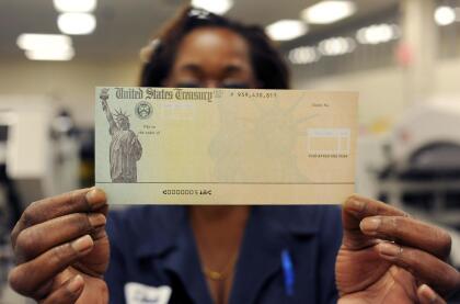 PHILADELPHIA, PA - JULY 18: In this photo illustration, Treasury employee Linda Tarkenton of Philadelphia, Pennsylvania holds a blank U.S. Treasury check before it's run through a printer at the U.S. Treasury printing facility July 18, 2011 in Philadelphia, Pennsylvania. U.S. President Barack Obama recently stated that he can't guarantee retirees will receive their Social Security checks in August if the House and Senate can not reach an agreement on reducing the deficit. (Photo by William Thomas Cain/Getty Images)