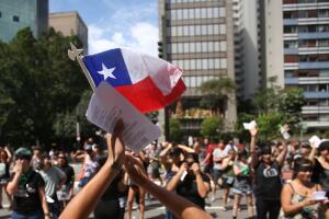 Members of a women's collective protest out side Chilean Consulate in Sao Paulo