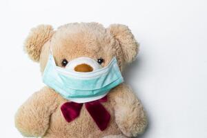 Cute teddy bear with face mask on his mouth