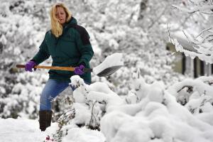 Laura Washington remueve la nieve frente a su casa en Kennesaw, Georgia, tras la nevada del sábado generada gélido frente que azotó al sur de EEUU.