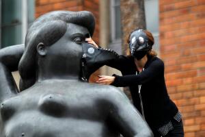 A group of environmentalists place gas masks on the faces of the sculptures of the artist Fernando Botero, protesting the high levels of air pollution in Medellin