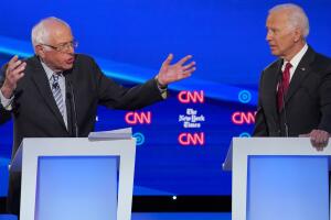 Democratic presidential candidate Senator Bernie Sanders speaks as former Vice President Joe Biden listens during the fourth U.S. Democratic presidential candidates 2020 election debate in Westerville, Ohio