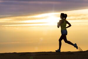 Athlete running at sunset on beach
