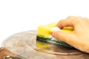 hand scrubbing cooking pot by scouring pad