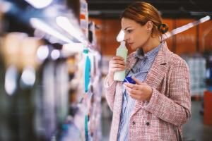 Woman buying food at grocery store.