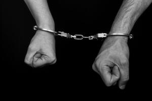 men and women cuffed hands together