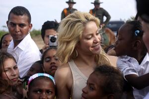 Colombian pop star Shakira greets a girl