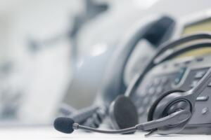 close up headset of call center and VOIP for communication technology on office table  in monitoring room for network operation job concept