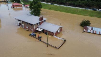 Homes submerged under flood waters from the North Fork of the Kentucky River are seen from a drone in Jackson, Kentucky, on July 28, 2022. - At least three people have died after torrential rains caused massive flooding in eastern Kentucky, leaving a number of people stranded on rooftops and in trees, the governor of the southeastern US state said Thursday. (Photo by LEANDRO LOZADA / AFP) (Photo by LEANDRO LOZADA/AFP via Getty Images)