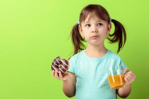 Girl with donut and  juice.
