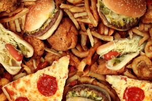 Fast food items like hot dogs, hamburgers, fries and pizza