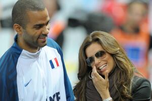 France's Tony Parker (L) shares a light