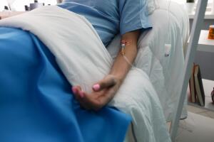 Hand of a young woman with a dropper in ward