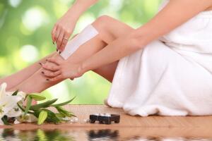young woman waxing her legs